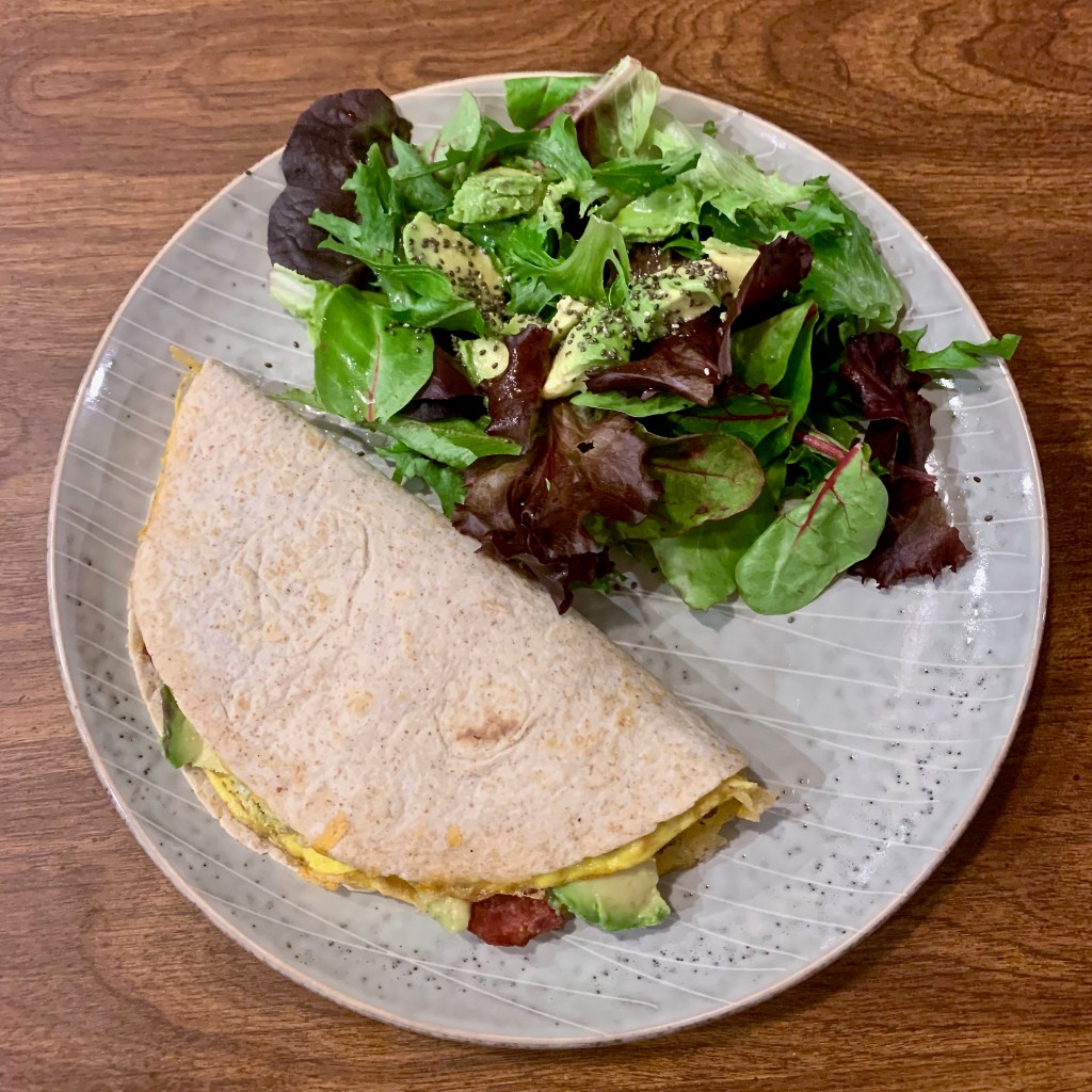 Spinach & Onion Omelette with cheddar, grilled in a low-carb wheat wrap, with turkey bacon and avocado sandwiched inside.